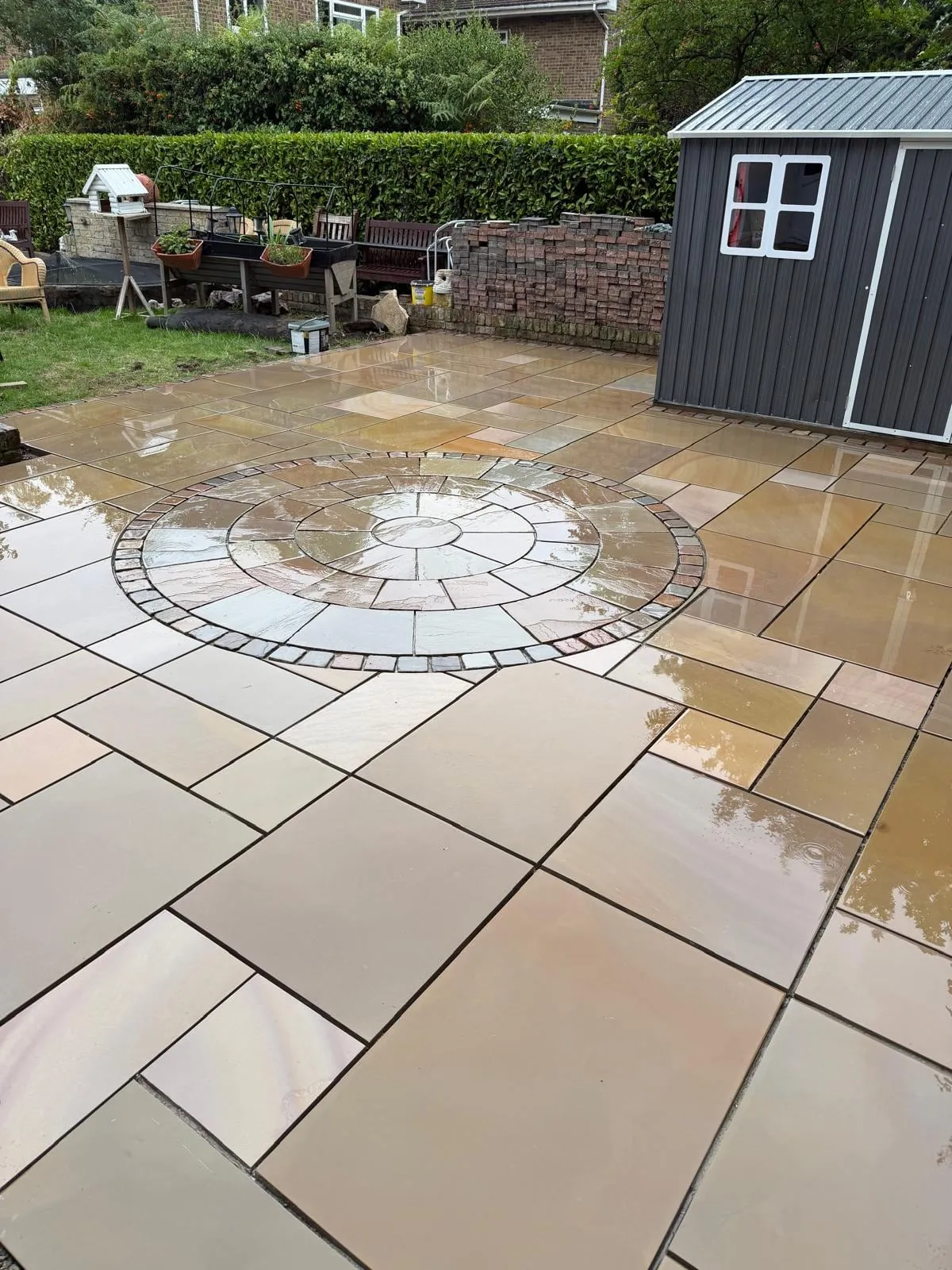 Finished sandstone patio with a circular paving feature