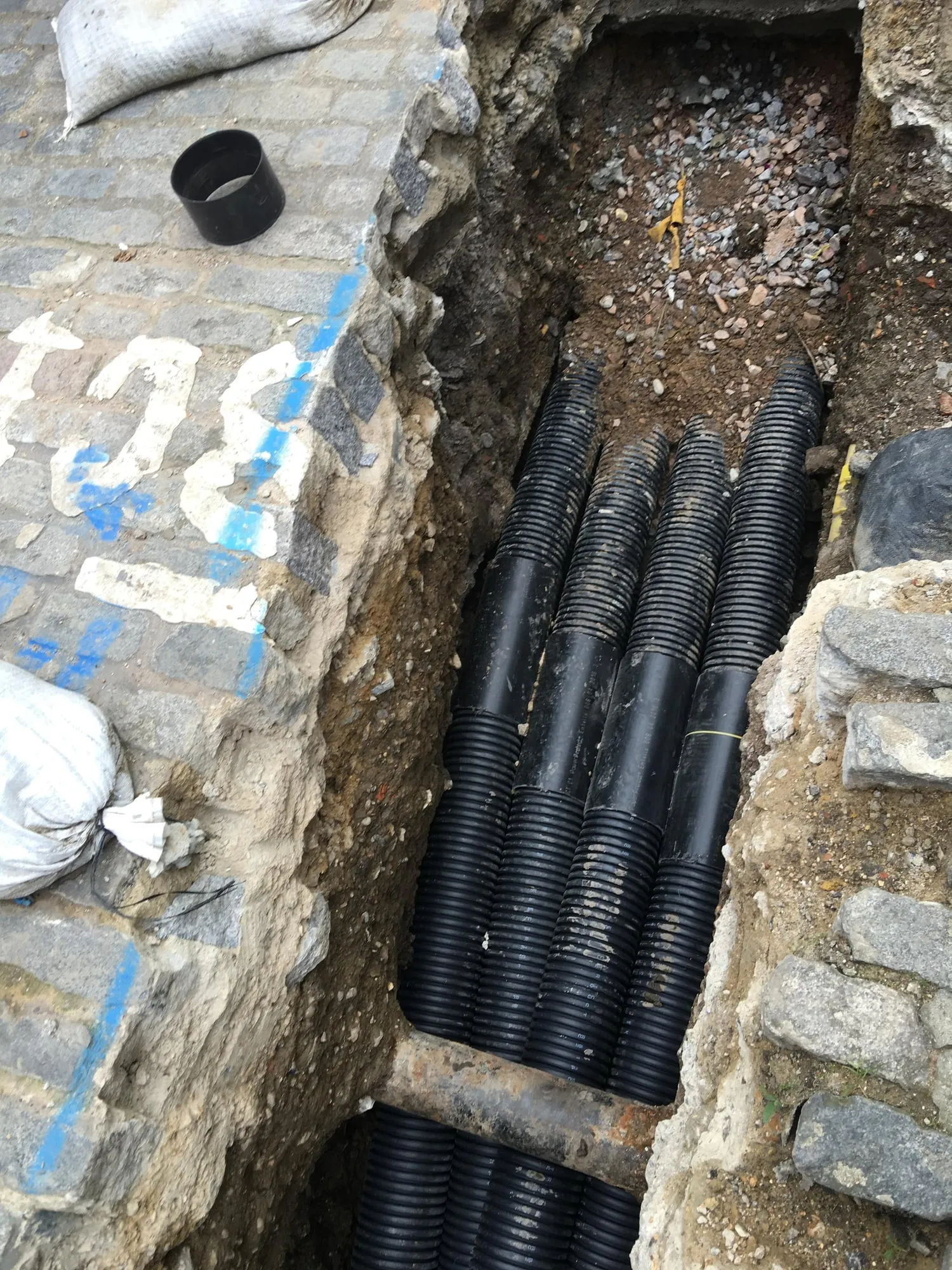 Black corrugated ducts laid in an open trench